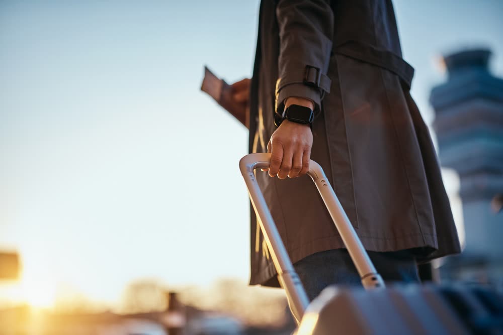 Traveller with a suitcase heading to the Schiphol departure hall